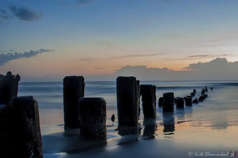 ocean sunset old pilings in water